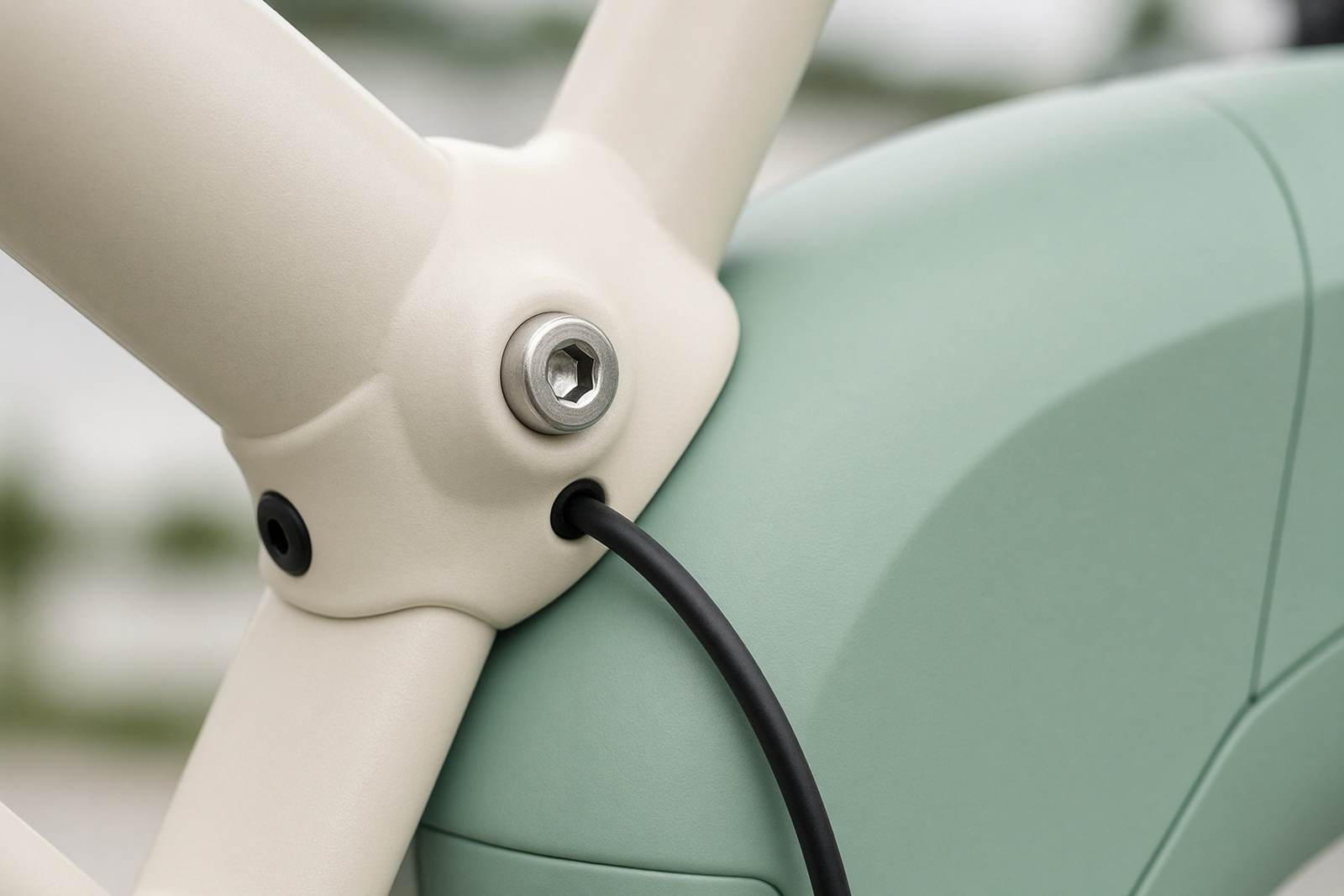 Close view of a cream e-bike frame and seafoam battery